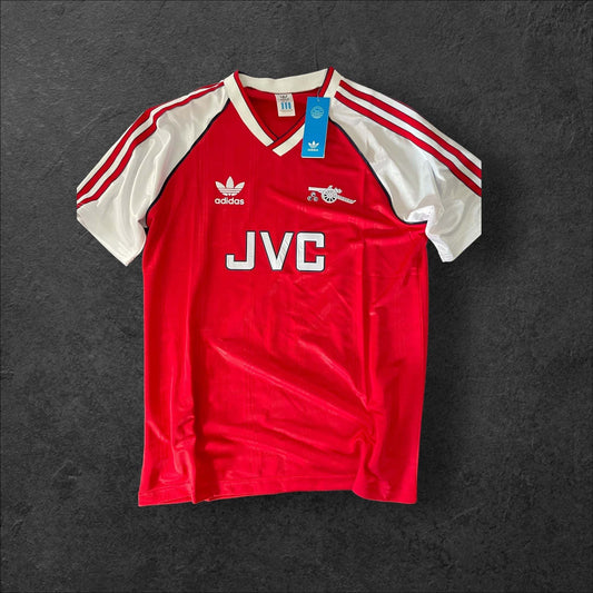 Yellow Arsenal Away 1988-90 football shirt with navy blue accents, featuring iconic crest and sponsor logo.