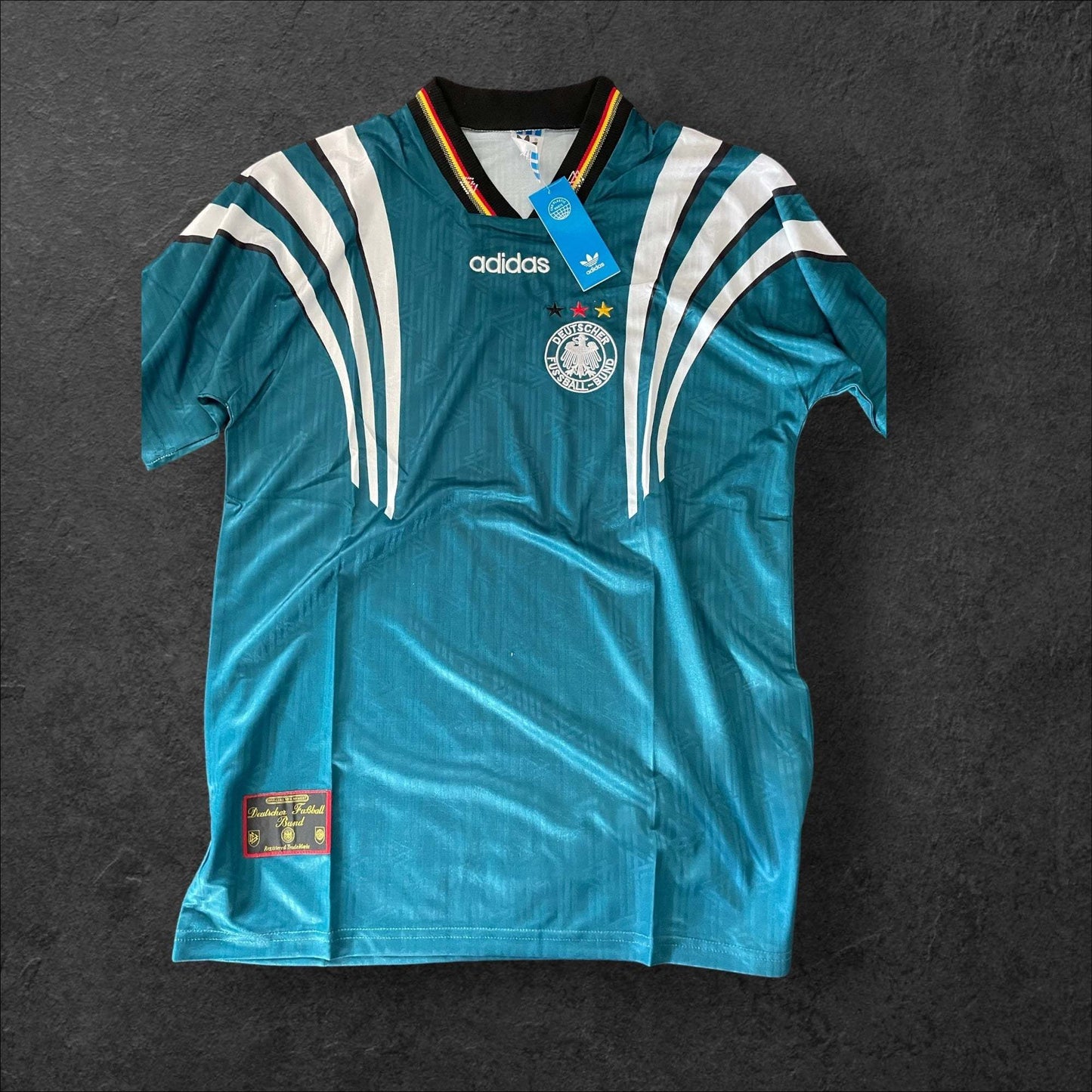 Germany Away 1996 retro soccer jersey with black, red, and yellow accents.