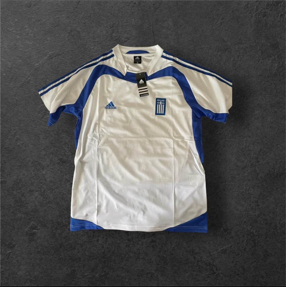 Greece Away 2004 Retro Soccer Jersey with blue and white design.