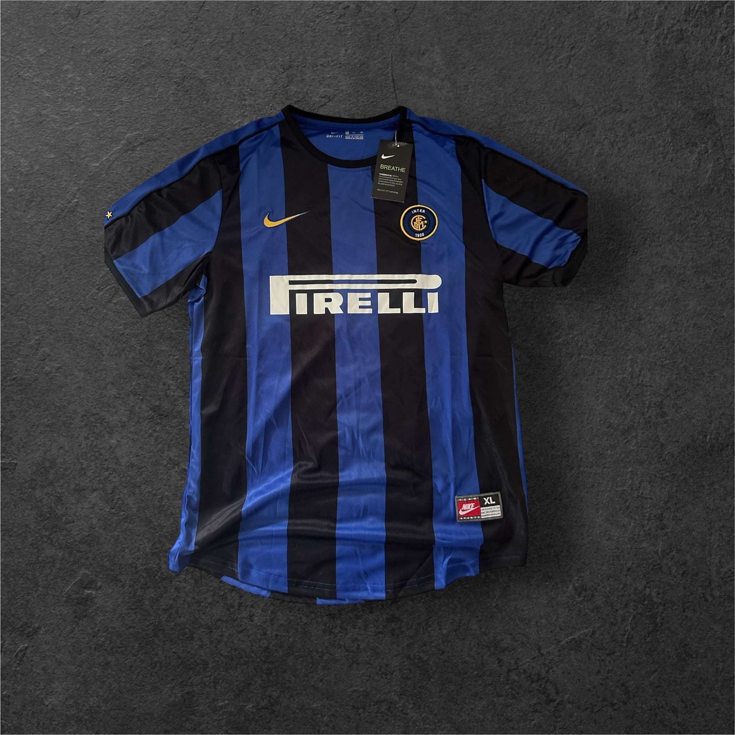 Inter Milan Home 1999-01 jersey with iconic black and blue stripes, associated with Christian Vieri, on a dark background.