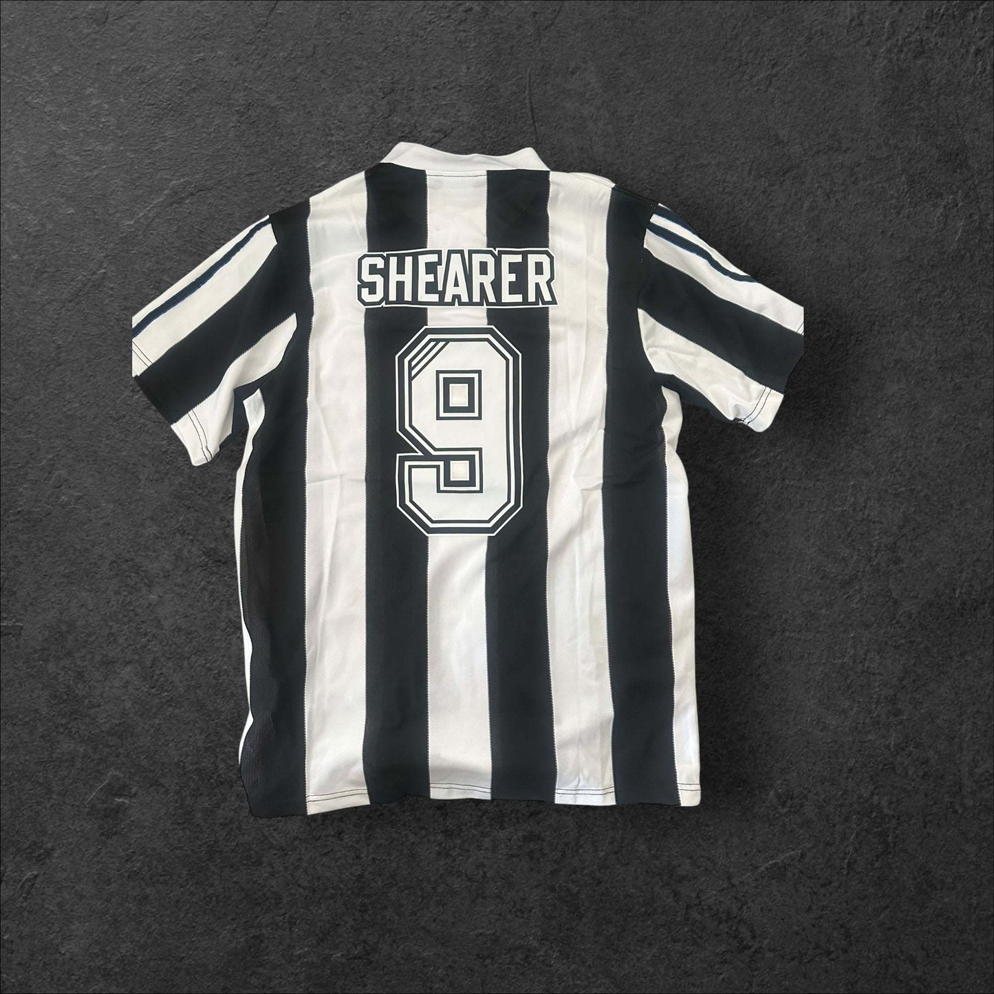 Newcastle United Home 1995-96 jersey featuring iconic black and white stripes and Newcastle Brown Ale logo.