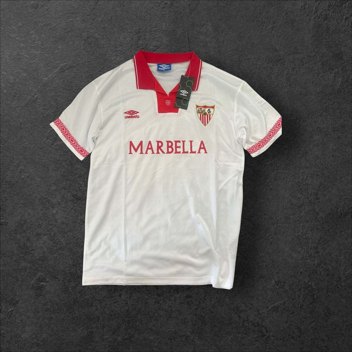 Sevilla Home 1994-95 jersey with red accents and crest, symbolizing club pride and legacy.